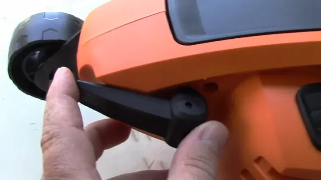 shows a close-up of a person’s hand adjusting the wheel on the side