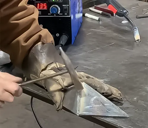 Person welding metal