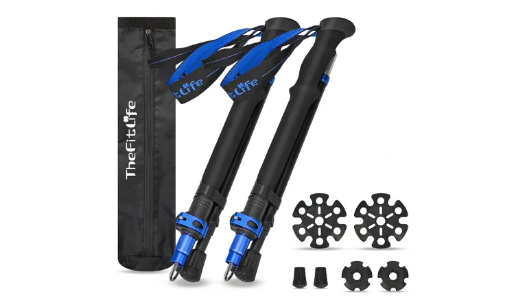 Black and blue TheFitLife trekking poles with comfortable grips and blue wrist straps, plus terrain accessories like snow baskets and rubber tips, all beside a branded carrying bag.