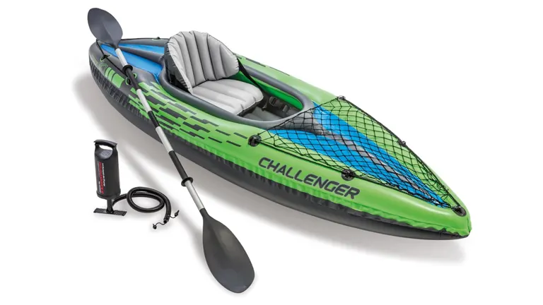 Inflatable green and black kayak labeled 'CHALLENGER', complete with a paddle, air pump, and front bungee cargo net.