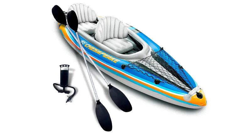 Inflatable kayak in blue, orange, and white, with 'CHEYENNE' branding, equipped with two paddles, an air pump, and a front net storage area.