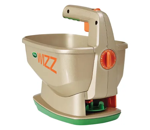 A handheld, battery-operated Scotts Wizz spreader in beige, designed for spreading seed, fertilizer, and ice melt.