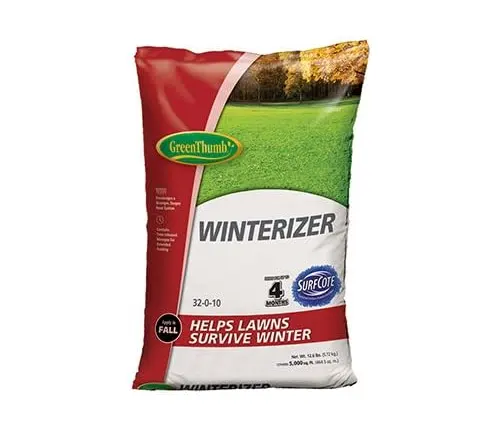 Bag of GreenThumb Winterizer lawn fertilizer, 32-0-10 formula, designed to help lawns survive winter, with a fall landscape image in the background.