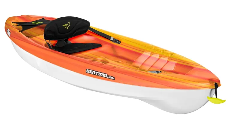 A vibrant orange and yellow Pelican Sentinel 100X sit-on-top kayak with a comfortable black seat and integrated storage, poised for recreational use.
