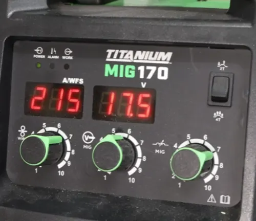 Close-up of the control panel on a Titanium MIG 170 welder showing voltage and amperage LED displays and adjustment dials.