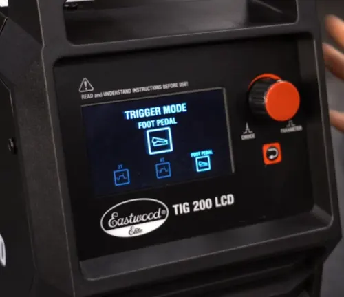 Alt text: "Eastwood Elite TIG 200 LCD welder's screen displaying trigger mode options and control knobs.