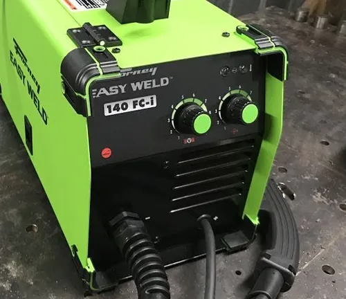 Close-up of the Forney Easy Weld 140 FC-I welder's front panel with knobs and input connections."