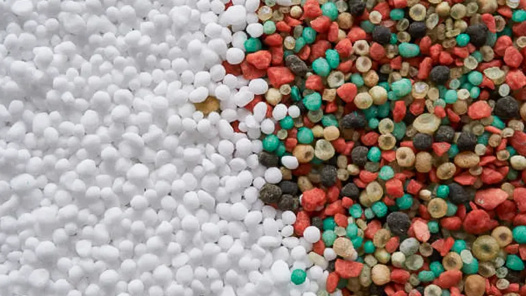 A close-up image showing two types of fertilizer granules: white nitrogen-rich granules on the left, and multi-colored NPK (nitrogen, phosphorus, potassium) blend granules on the right.

