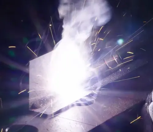 Intense welding spark light and smoke from metal welding.