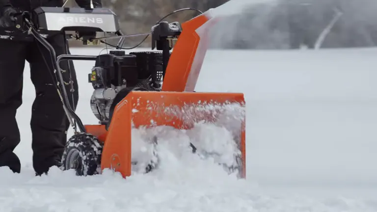Person pushing Ariens Classic Snow Blower on a full of snow area