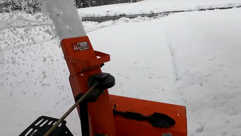 Ariens Classic Snow Blower in front of the driveway blowing ton of snow