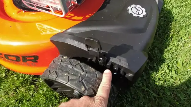 Person pointing the height adjuster of Ariens Razor 21 Mower