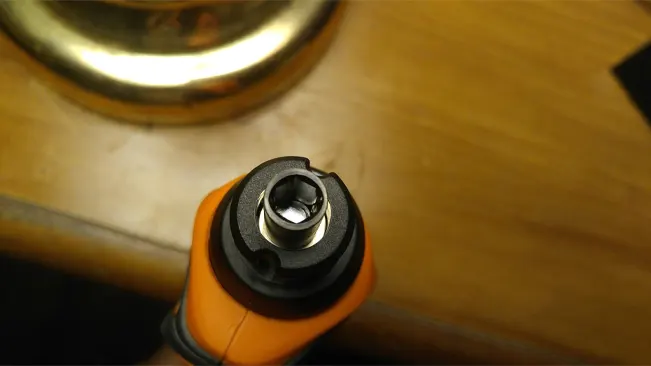 Top view of BLACK+DECKER 4V MAX Cordless Screwdriver's (BDCS20C) chuck on a wooden surface