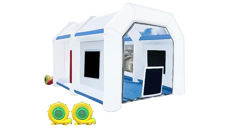 A white inflatable paint booth with blue trim, a clear front view, and yellow blowers at the side