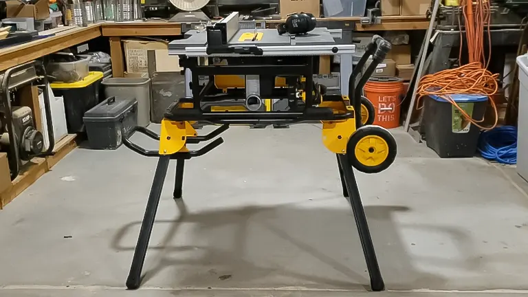 A portable, wheeled woodworking table saw set up in a workshop, ready for use by expert woodworkers