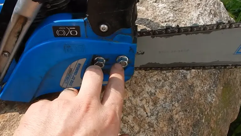 Person pointing the two studs of Blue Max 57cc Chainsaw