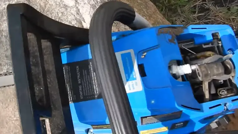 Blue Max 57cc Chainsaw sitting on the rock  with no top cover