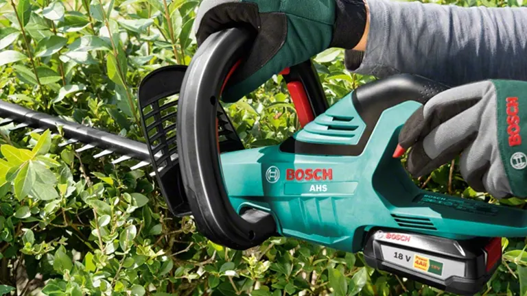 Person using Bosch AHS 50-20 LI Cordless Hedge Trimmer