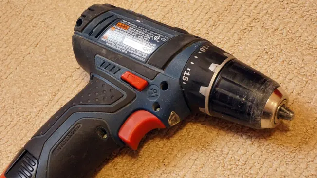 A used Bosch PS31-2A 12V Max Drill/Driver Kit on a carpeted floor.