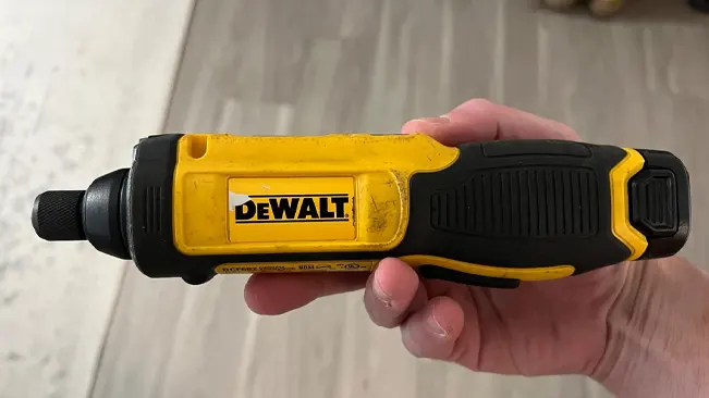 Hand holding a yellow and black DEWALT 8V MAX Cordless Screwdriver