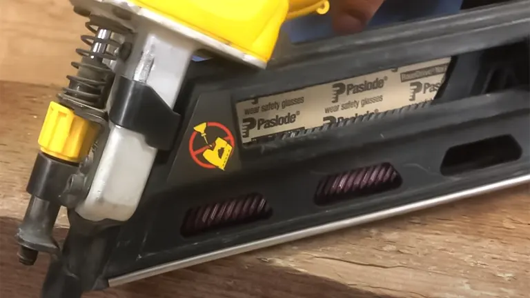 Close-up of the magazine and safety label on a DEWALT DCN692B 20V MAX XR Framing Nailer