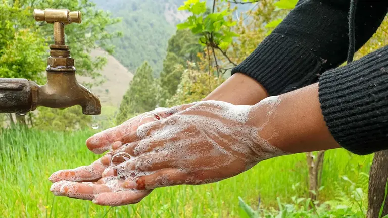 Person washing hands in the forest