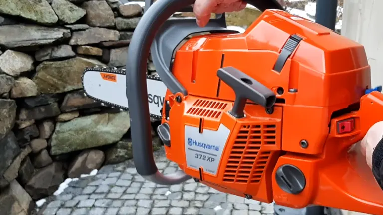 Person holding the Husqvarna 372 XP Chainsaw closer look