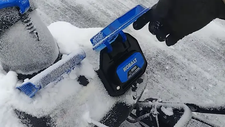 Person opened the battery cover of Kobalt 40V Snow Blower