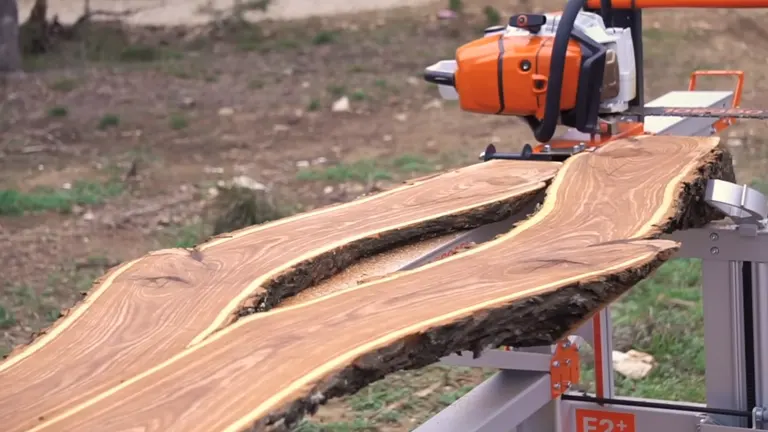 Logosol F2 Chainsaw Mill in action, cutting through a large piece of wood.