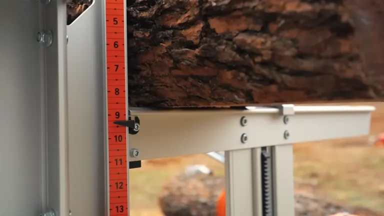 Close-up of a Logosol F2 Chainsaw Mill’s measurement scale and structural detail with a log in place.