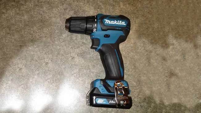 Makita FD07R1 12V Max CXT Lithium-Ion Brushless Cordless Drill on a textured surface.