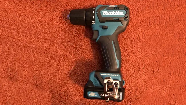 A Makita FD07R1 12V Max CXT brushless cordless drill on a red carpet