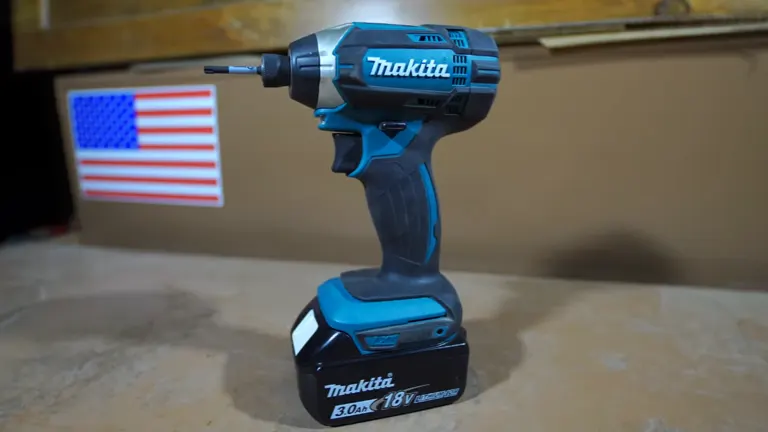 Makita XDT11Z 18V Impact Driver standing in the desk with american flag on the background