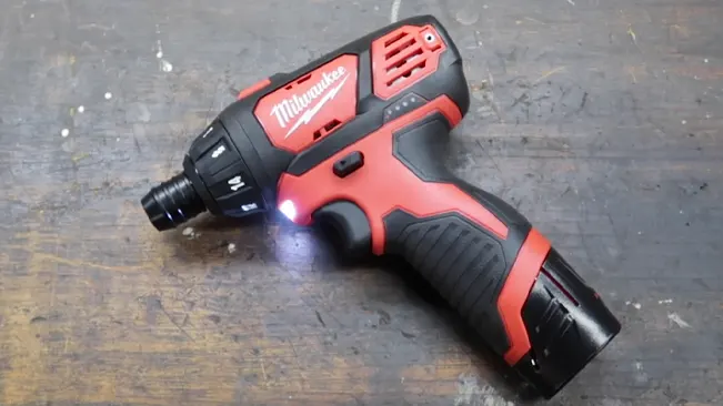 Milwaukee 2401-22 M12 cordless screwdriver on wooden surface