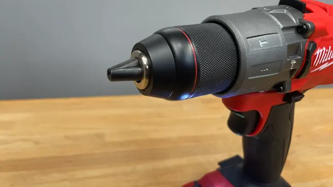 Close-up of a red and black Milwaukee cordless hammer drill with an adjustable chuck