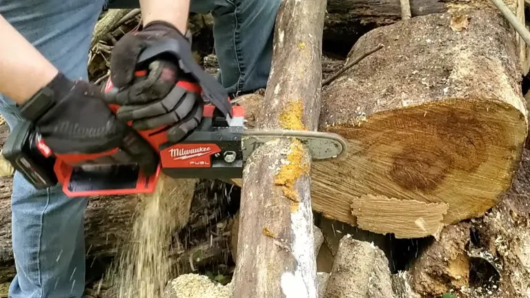 Person using Milwaukee M12 FUEL Pruning Saw cutting 3 meter log using 2 hands