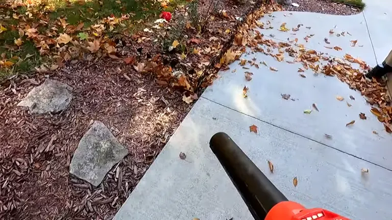 Milwaukee M18 Blower blowing leaves near pathway