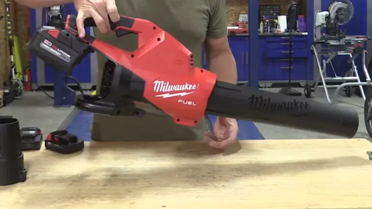 Person lifting the Milwaukee M18 Blower with 2 fingers