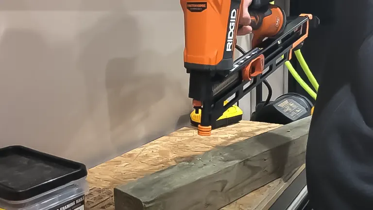Ridgid R350CHD framing nailer in use, securing lumber on a workbench