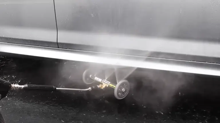 Person using Ryobi Pressure Water Broom under the car