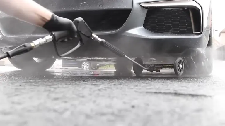 Person using the Ryobi Pressure Water Broom under BMW car