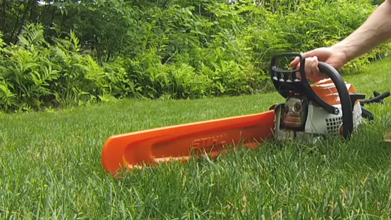 Person holding the STIHL MS 171 Chainsaw laying on the grass