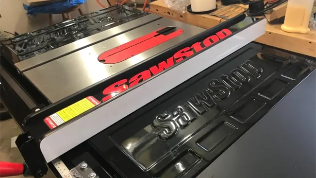 Angled view of a SawStop table saw with logo and safety label, in a woodworking workshop