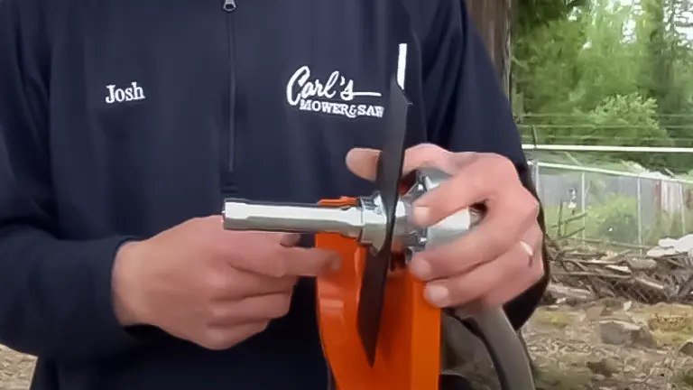Close-up of a person named Josh demonstrating the handle and throttle control mechanism of a Stihl FC 56 C-E lawn edger