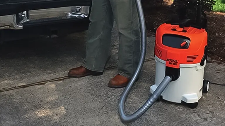 Stihl SE 122 vacuum cleaner in use outdoors near a vehicle
