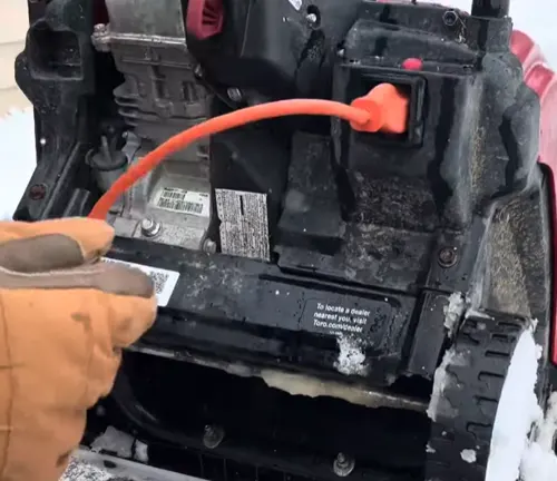 Person putting extension cord in the Toro Power Clear 518 ZE