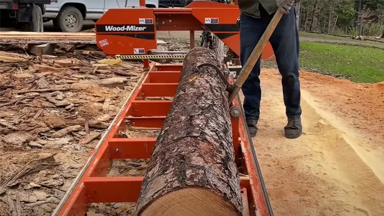 Man putting log into the Wood-Mizer LT15 Bed