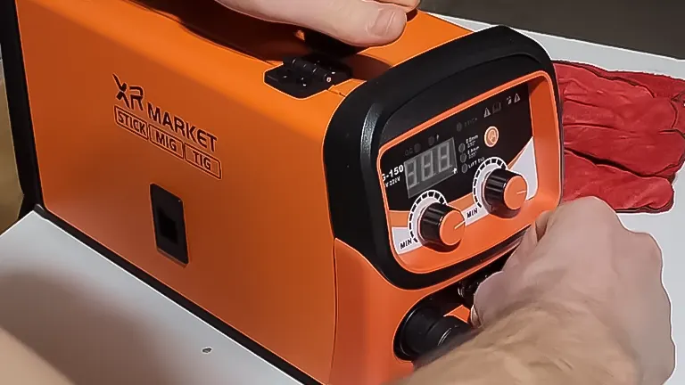 Close-up of a hand adjusting the dials on the control panel of an XR MARKET 150Amp Dual Voltage Welder Machine