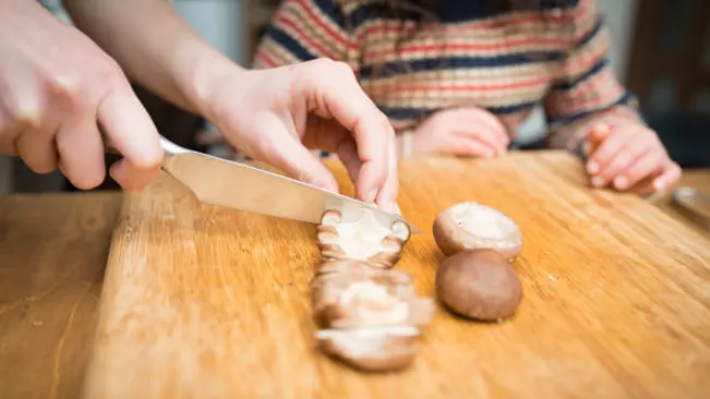 hand with Knife Chopping Mushroom