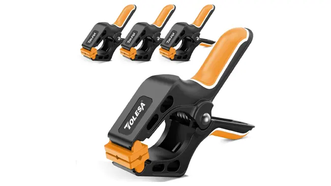 A set of Tolesa nylon spring clamps with black bodies and orange grips.